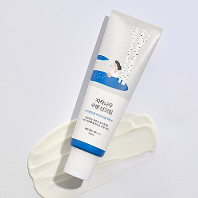 Round Lab Birch Juice Moisturizing Sun Cream 50ml tube with creamy texture on white surface.