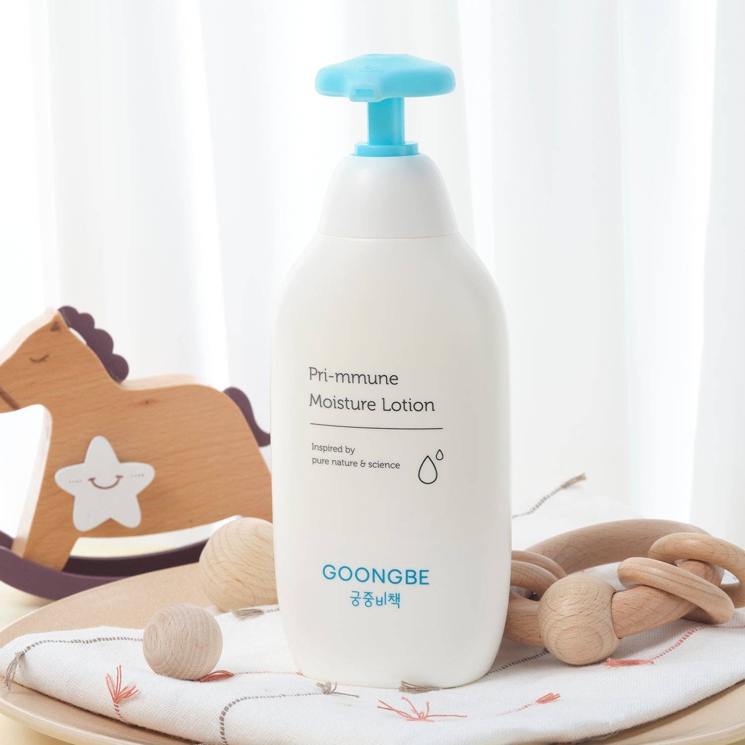 GOONGBE lotion bottle with wooden toys on a white background