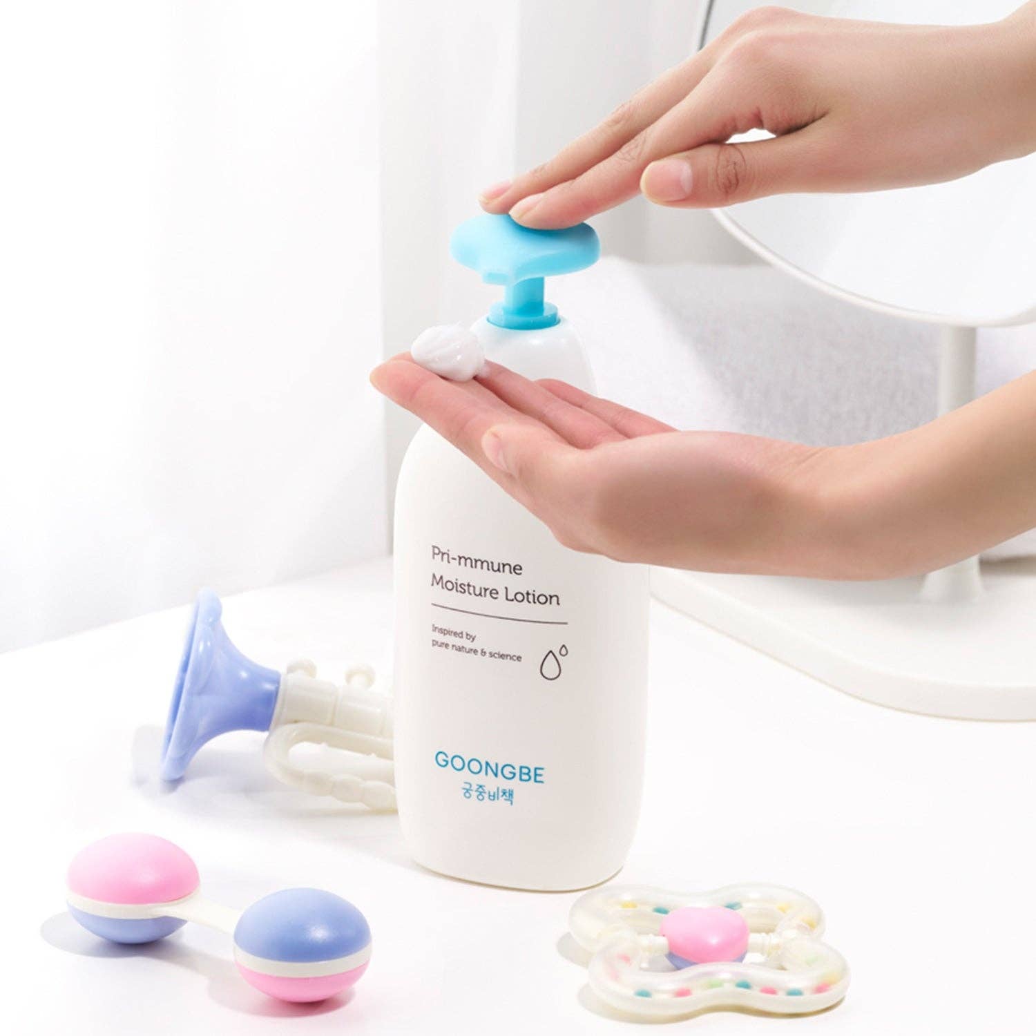 Person applying GOONGBE lotion to their hand with a white background
