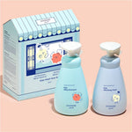 Two bottles of GOONGIE Kids Silky Shampoo and Mild Body Wash with a packaging box on a peach background